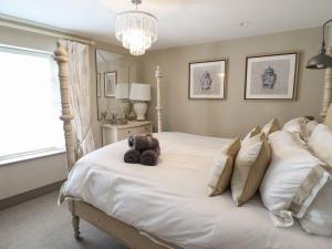 a bedroom with a bed with a teddy bear on it at 2 Llewelyn Street in Conwy
