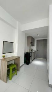 a kitchen with a wooden table and a green stool at Arc Tower Condominium 1930 and 1727 in Cebu City