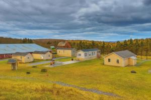 an aerial view of a farm with houses and trees at Tranquil Trails Cabin & Suites At Equestrian House in Pleasant Mount