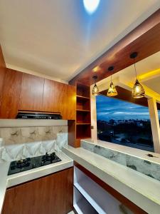 a kitchen with a stove top oven next to a window at Agustik Villas in Badung