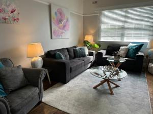 a living room with a couch and a table at Daisy Cottage on Duke 1BR in Yarram