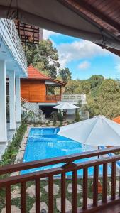 a view from the balcony of a house with a swimming pool at STHANATAPA HILL's in Sidemen