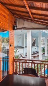 a room with a balcony with a view of the ocean at STHANATAPA HILL's in Sidemen