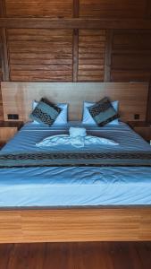 a bed with blue sheets and pillows on it at STHANATAPA HILL's in Sidemen +74 photos