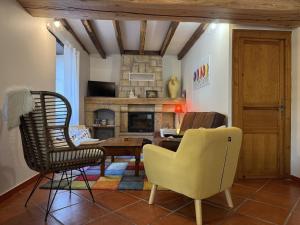 a living room with a table and chairs and a fireplace at Xuhinxaharea in Banca