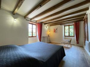 a bedroom with a blue bed and red curtains at Xuhinxaharea in Banca