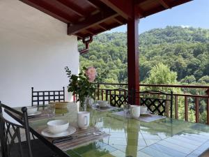 a table with a vase of flowers on a balcony at Xuhinxaharea in Banca