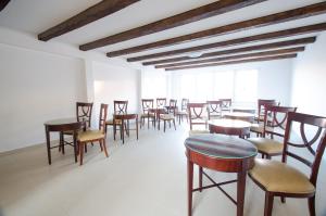 a group of tables and chairs in a room at Hotel EKA in Sebeş