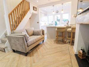 a living room with a couch and a kitchen at 8 Crown Lane in Conwy