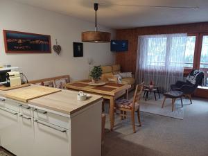 a kitchen and living room with a table and chairs at Studio Le Cocon in Champéry
