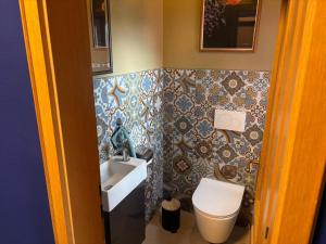 a bathroom with a sink and a toilet at Ferienwohnung Raabenhorst in Oettingen in Bayern +6 photos