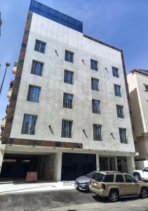 a large building with cars parked in front of it at لافيرا هاوس in Taif