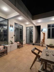 a large living room with a table and benches at The Peace Corgaon in Corgao