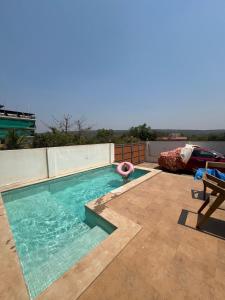 a swimming pool on the roof of a house at The Peace Corgaon in Corgao