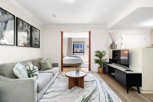 a living room with a couch and a table at Walk & Wander - A Sepal Stay in Perth