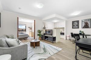 a living room with a couch and a table at Walk & Wander - A Sepal Stay in Perth