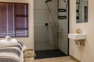 a bathroom with a shower and a sink at Sea Spray Self Catering in Duyker Eiland in Britannia Bay +32 photos