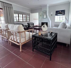 a living room with a couch and a table at Scafell homestead, Cobham, Himeville in Ixopo