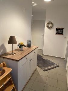a kitchen with a table with a lamp and a door at Wohnung Jolmes in Dahme +7 photos
