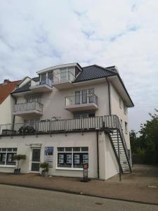a large white building with a staircase on it at Wohnung Jolmes in Dahme