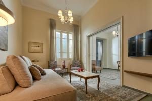 a living room with a couch and a tv at Vava Residence in Heraklio