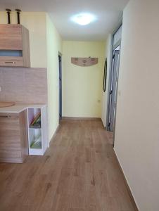 an empty room with a hallway with a wooden floor at Martin apartman in Kruče +7 photos