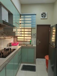 a kitchen with a sink and a counter top at AZALEA Homestay Segamat in Segamat