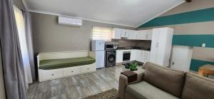 a living room with a couch and a kitchen at Westbrook Hideaway in Westbrook