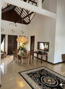 a living room with a table and a dining room at Villa Stella Garden in Senggigi