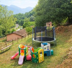 a playground with a trampoline in the grass at Masia La Cadamont in Sant Joan les Fonts