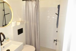a bathroom with a shower and a toilet and a sink at Villa D - Kamari Village in Aliko Beach +84 photos