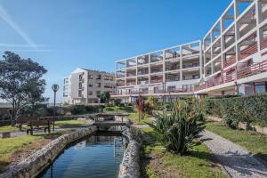 a river in front of a large building at Spacious Seafront Residence - Family Friendly in Vila Nova de Gaia