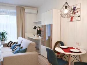 a living room with a couch and a table at Kis kertes lakás in Pusztavacs