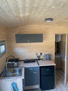 a kitchen with a sink and a counter top at maringotky Šumava in Dlouhá Ves