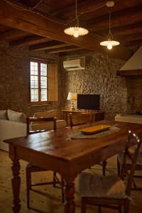 a living room with a wooden table and a couch at Corte dei Mori - Historic Apartments Lazise in Lazise