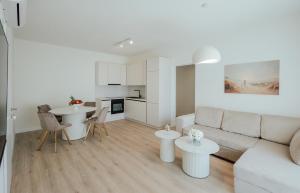 a white living room with a couch and a table at Villa Saint Hill in Međugorje