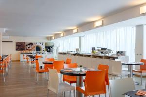 a restaurant with tables and chairs and a counter at Golf Hotel Milano in Opera