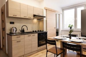 a kitchen with a table and a stove top oven at Apartment Spišská Nová Ves in Spišská Nová Ves