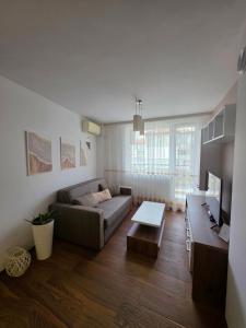 a living room with a couch and a table at APart Residence Shumen 1 in Shumen