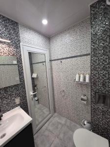 a bathroom with a shower and a sink at APart Residence Shumen 1 in Shumen +16 photos