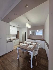 a kitchen and dining room with a table and chairs at APart Residence Shumen 1 in Shumen