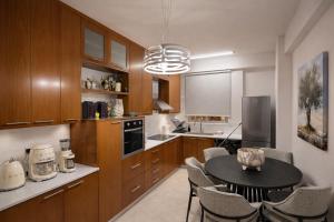 a kitchen with a table and chairs in a room at Mackenzie Beachfront Panorama in Larnaca