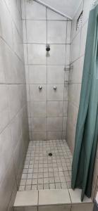 a bathroom with a shower with a tiled floor at Westbrook Hideaway in Westbrook +7 photos