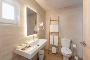 a white bathroom with a sink and a toilet at Hotel BH Los Ángeles in Benidorm