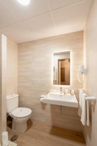 a white bathroom with a toilet and a sink at Hotel BH Los Ángeles in Benidorm +22 photos