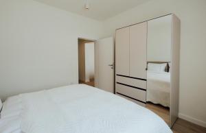 a bedroom with a white bed and a large mirror at Villa Saint Hill in Međugorje