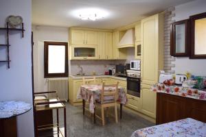 a kitchen with yellow cabinets and a table in it at IL GINEPRO B&B in Piamaggio +31 photos