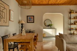 a dining room with a wooden table and chairs at The Garden Home in Arusha
