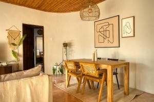 a dining room with a wooden table and chairs at The Garden Home in Arusha +90 photos