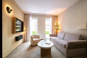 a living room with a couch and a table at Harmony Valley Resort in Szklarska Poręba